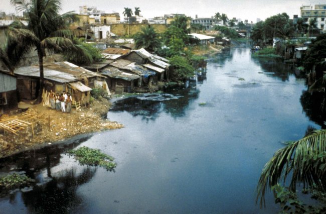 Slum housing along a river in Bangladesh